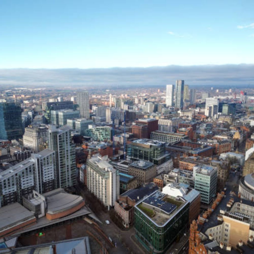 Aerial drone shot across Manchester shot from the west looking east at Deansgate Square, Manchester, UK