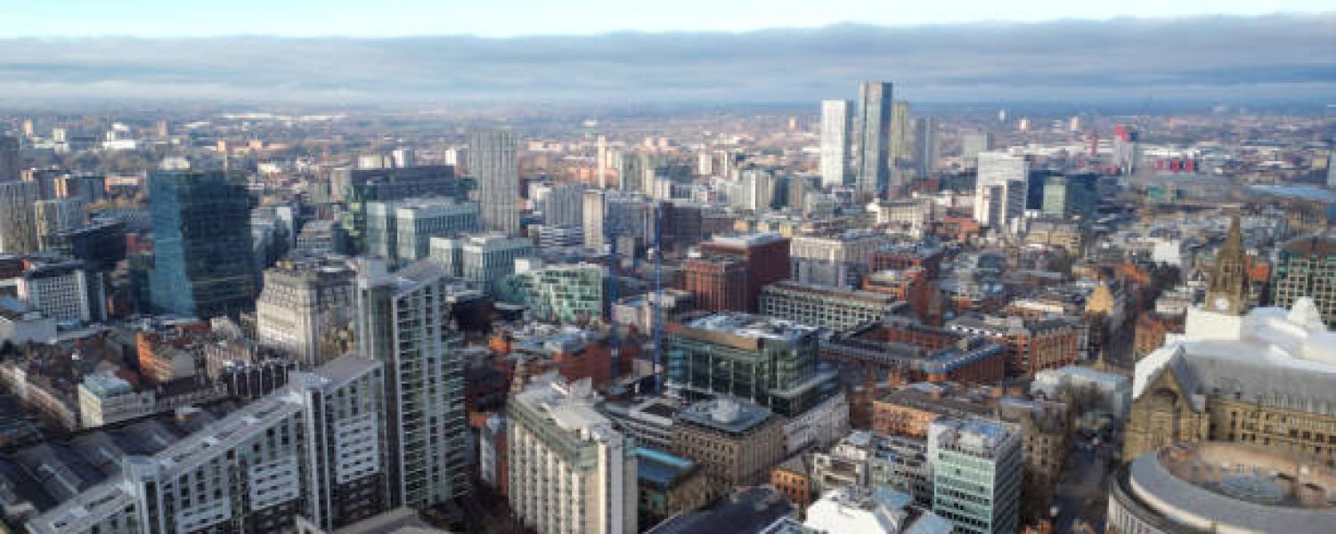 Aerial drone shot across Manchester shot from the west looking east at Deansgate Square, Manchester, UK